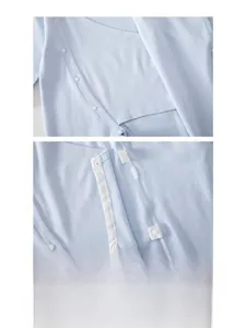 Close-up of soft blue cotton baby onesie with secure snaps and double-layered belly guard