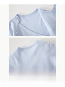 Detail of light blue cotton baby bodysuit featuring soft ribbed neck and shoulder snaps
