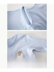Detail view of boneless stitching and cute bear embroidery on cotton baby bodysuit