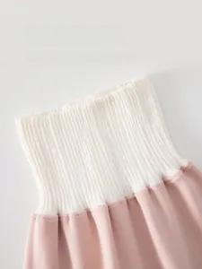 Close-up of high-waisted ribbed elastic waistband on baby pants for belly protection