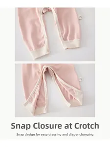 Detail view of baby romper featuring snap buttons at the crotch for easy diaper changes