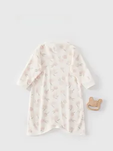Close-up of baby cotton sleepwear featuring pink cherry prints and ribbed cuffs detail