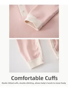 Detail of pink baby pajama set showing elastic ribbed cuffs and durable snap buttons