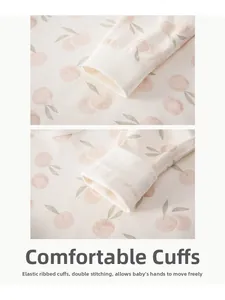 Detail of baby sleepwear showing elastic ribbed cuffs and double-stitched cotton fabric