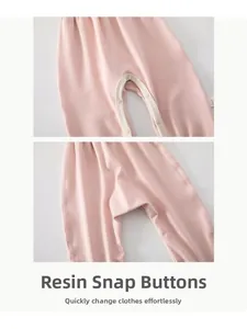 Detail of resin snap buttons on light pink cotton baby trousers for easy dressing