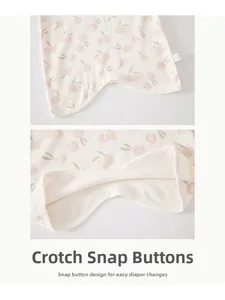 Detailed close-up of convenient crotch snap buttons on cotton baby romper for easy changing