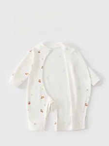 Detail of baby cotton romper with red cherry prints and side snap button closure