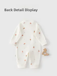 Close-up of cherry pattern on soft cotton baby romper with back detail and wood horse decor