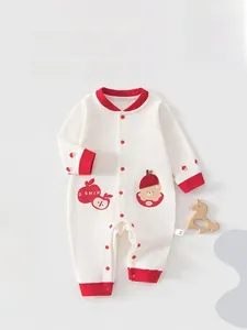 Detail of newborn cotton bodysuit featuring red bear embroidery and secure snap closure