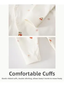 Detailed close-up of soft ribbed cuffs and high-quality stitching on cotton baby romper