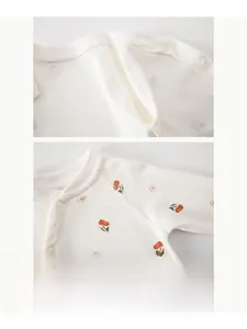 Detail of baby cotton onesie with orange fruit print showing flat seam stitching