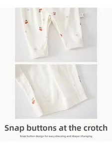 Detail view of the snap buttons on the crotch of a pure cotton baby cherry print jumpsuit