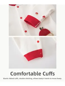 Detail of baby romper featuring elastic ribbed cuffs and double-stitched cotton fabric
