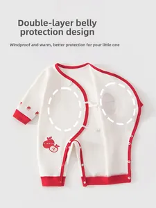 Detail of red apple print and double-layered belly guard on cotton baby bodysuit