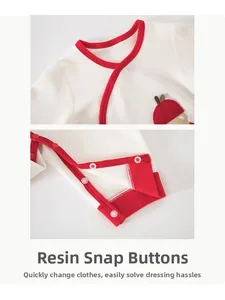 Detail of baby bodysuit with resin snap buttons and soft cotton fabric texture