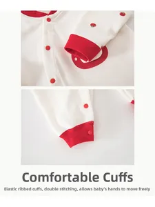 Detailed view of elastic ribbed cuffs and double stitching on cotton baby romper