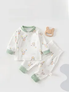 Detail of infant organic cotton side-snap pajama set with green panda cartoon print