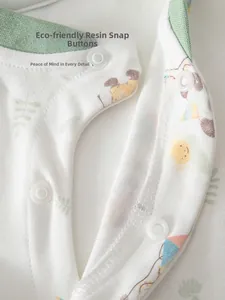 Detail of eco-friendly resin snap buttons on cotton baby pajamas with animal patterns