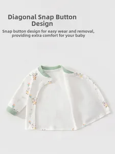 Detail of baby side-snap cardigan with panda print and soft green ribbed trim