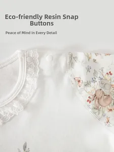 Detail of baby cotton top with lace collar, eco-friendly resin snaps and rabbit prints