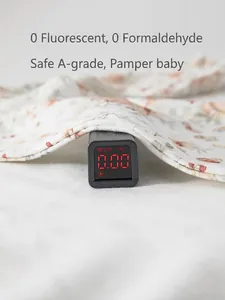 Cotton baby romper with floral print showing zero fluorescence on a digital tester