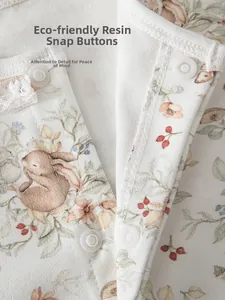 Detail of eco-friendly resin buttons and delicate lace on cotton baby romper floral fabric