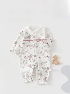 Detail of baby romper with pink ribbon bow, unicorn print and ruffled sleeve cuffs