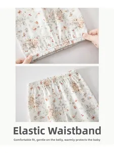 Detail of baby girl floral cotton pants showing elastic waistband and soft bunny prints
