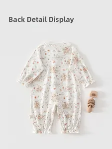 Detail showing the lace collar and floral rabbit print on newborn cotton romper