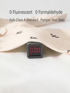 Safety testing for organic cotton baby romper showing zero fluorescence on digital monitor