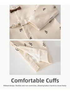 Detail of baby romper featuring bird prints, ribbed cuffs, and snap button closure