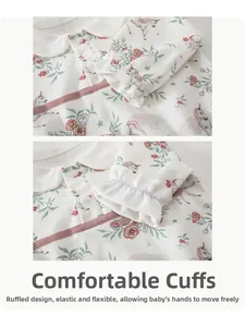 Detail of the soft cotton neckline and elastic lace cuffs with pink rose and unicorn print