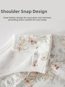 Détail d'un barboteuse bébé fleurie avec boutons pression et bordure en dentelle