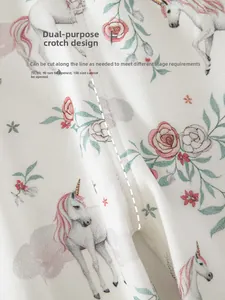 Detail of baby cotton pants showing adjustable crotch design with cute unicorn patterns