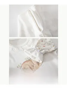 Detail of infant cotton sleepwear showing seamless sewing and lace collar with bunny print