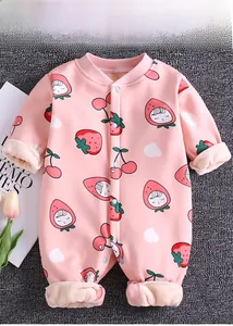 Detail of pink baby romper showing thick white fleece lining and cute strawberry prints