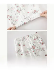 Detail of the elastic waistband on soft cotton floral baby pants showing high stretch