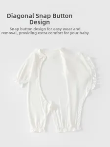 Detail of white long-sleeved baby bodysuit with ruffles and side snap buttons
