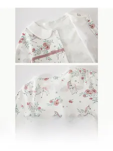 Detail of baby romper featuring floral unicorn print, lapel collar and snap fasteners