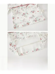 Detail of baby cotton top hem with unicorn print and durable double stitching