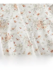 Detailed texture of baby cotton romper with rabbit floral print and button closure