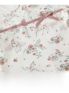 Detail of baby cotton top with unicorn floral print, pink bow and button neckline