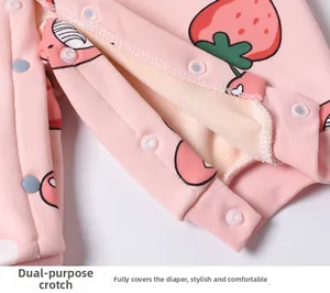 Detail of pink strawberry baby romper with warm fleece lining and snap crotch design