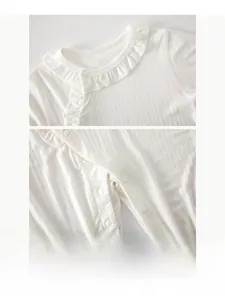 Detailed view of baby romper featuring soft ribbed cotton and resin snap buttons