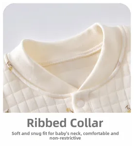 Close-up of ribbed neckline on quilted cotton baby romper with soft cherry pattern