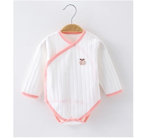 Detail eines weißen Baby-Bodys aus Rippbaumwolle mit rosa Saum und Apfelstickerei