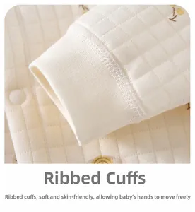 Detail of ribbed cuffs and quilted fabric with bear prints on baby warm jumpsuit