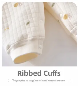 Detail of baby quilted romper ribbed cuffs with cute snail and leaf cartoon pattern