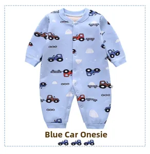 Detail view of baby romper featuring blue tractor prints and convenient front snap buttons