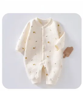 Detail view of quilted thermal baby romper with cute snail and cherry cartoon patterns